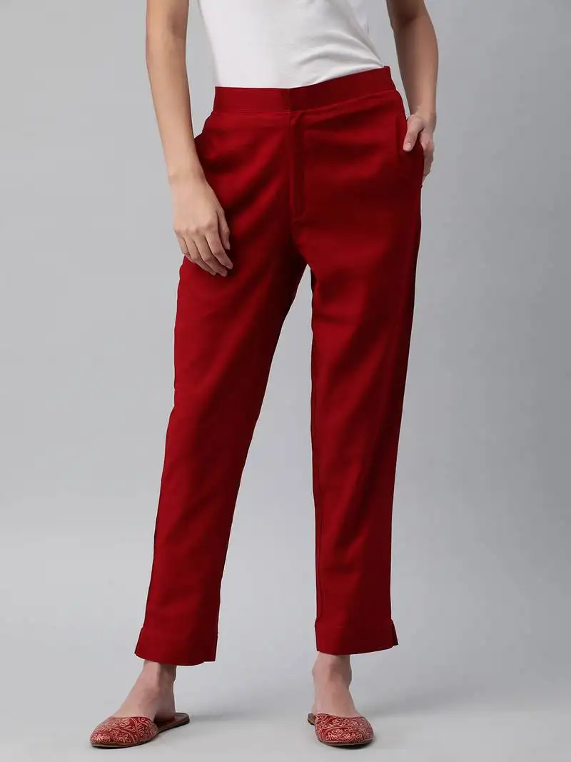 A maroon ankle length coton linen pant with plain belt in front.